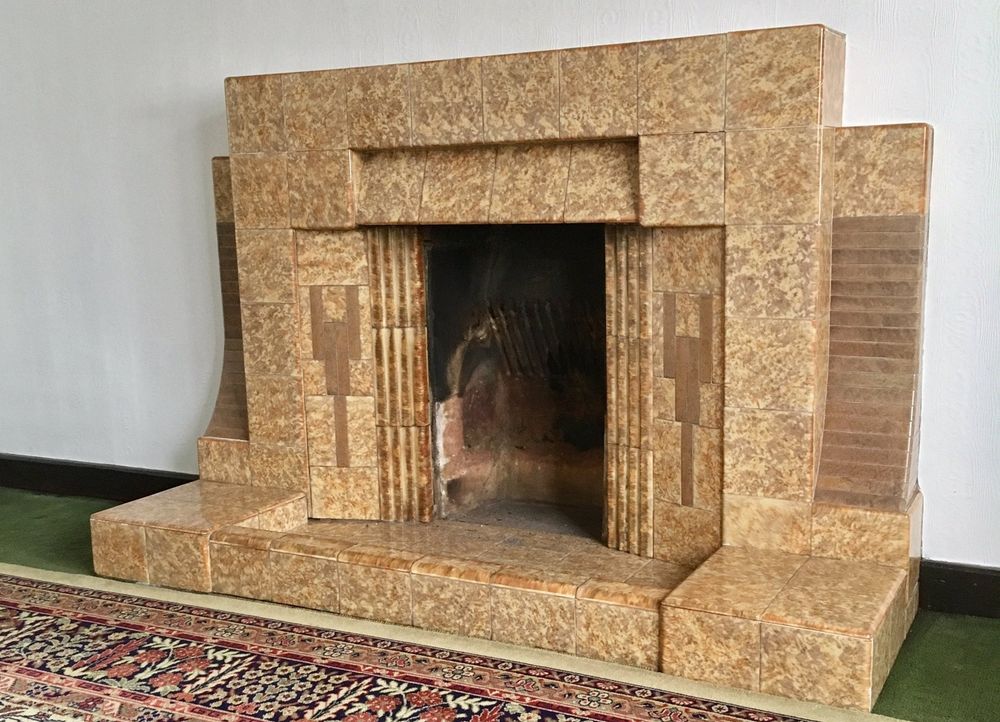 Mottled brown and beige tiled Art Deco fireplace, courtesy of Shire Surveyors in Leicestershire, England, on X.