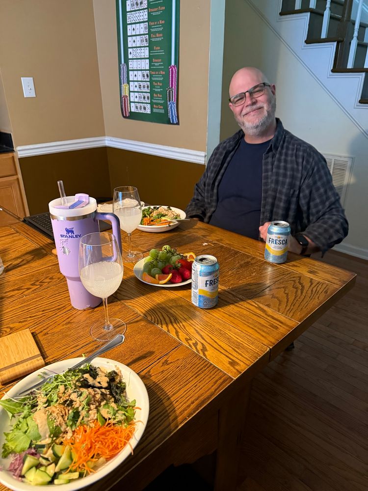 Date night tuna bowls with wine glasses full of Fresca. A love smiling for the camera. 