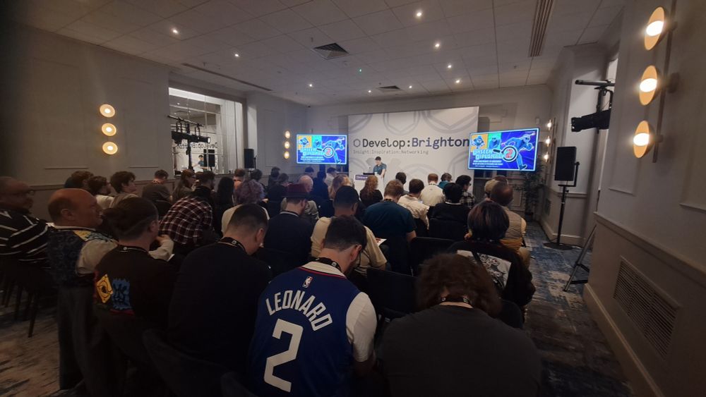 Lots of people in a room ready for a talk