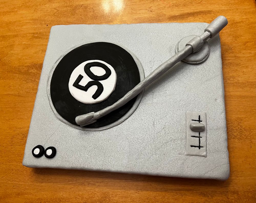 A “cake” made to look like a record player with the numbers 50 in the middle of the record