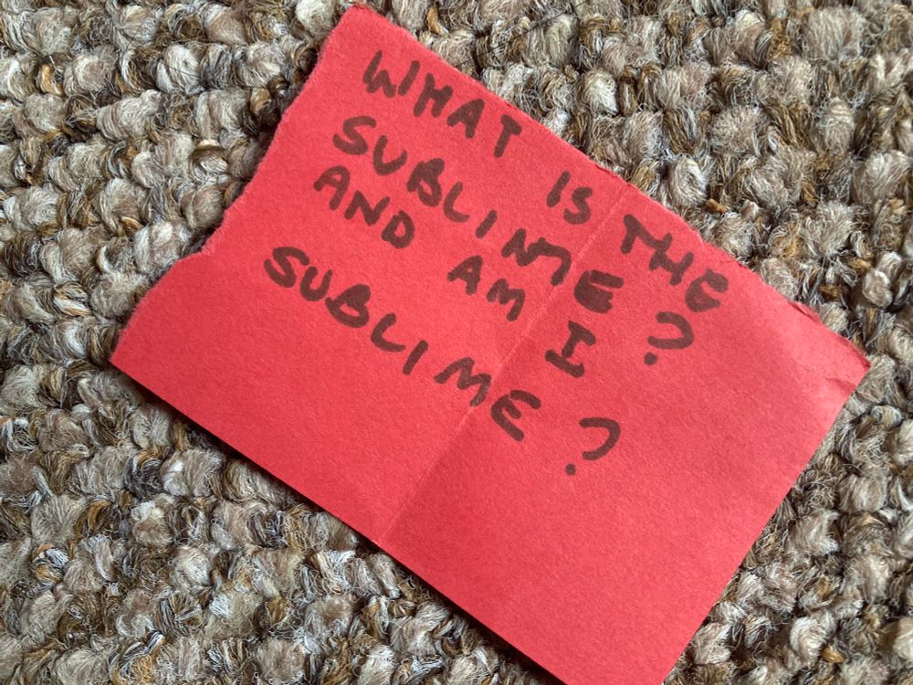 ‘What is the sublime and am I sublime? Handwritten on a Small red card
