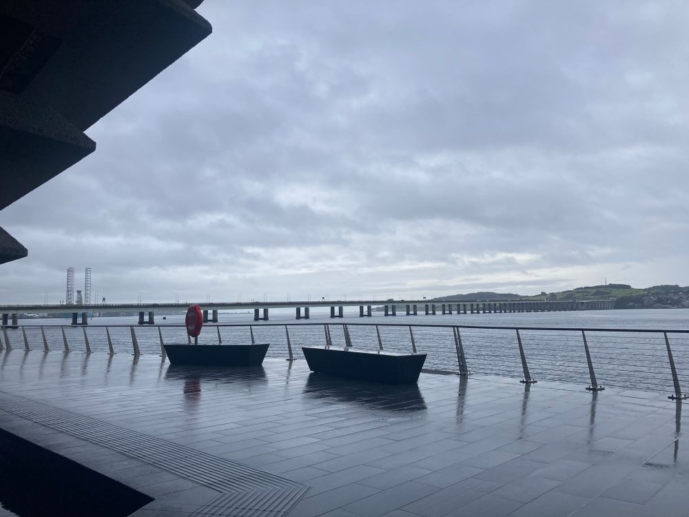 View of the Tay Firth towards the vehicle bridge from under the arch of the V and A museum Dundee on a grey drizzling morning