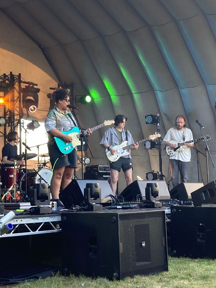 Sacred Paws on stage with two guitars, bass and drums all looking very cool