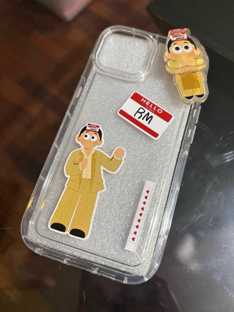 A phonecase decorated with Lost Joon inspired stickers and a hipper on top.
