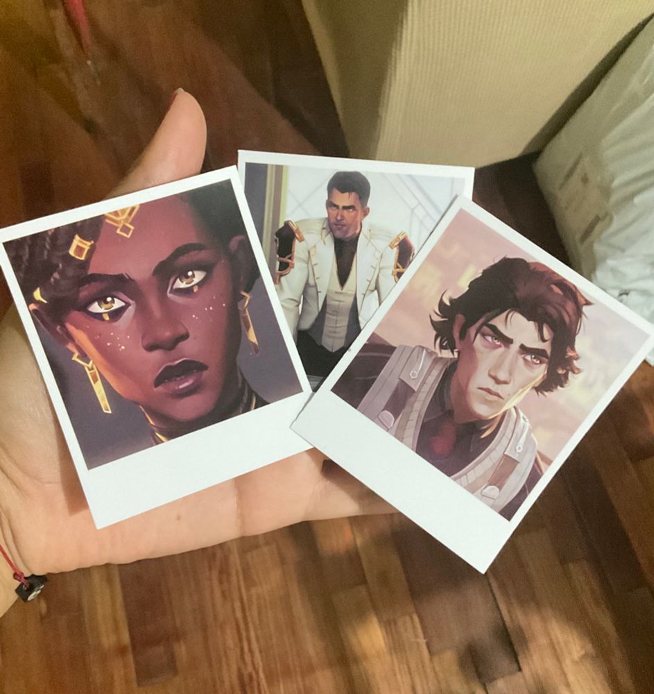 Polaroid prints of Mel, Jayce and Viktor which come as freebies with each of my figurines. 
