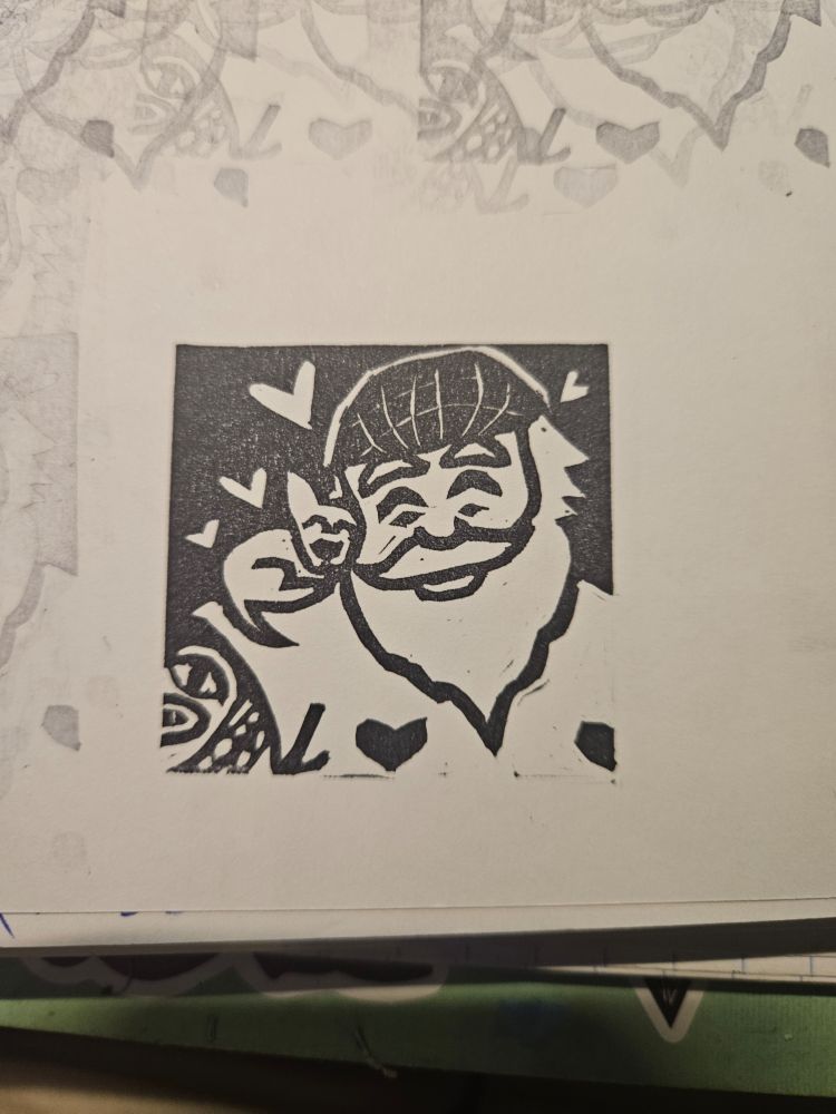 Picture of a roughly 2"x2" stamp of Fang smiling with his eyes closed with his chihuahua snuggled up on his shoulder. Their heads are touching, Fang wears a bandana and cut off shirt with hearts on the nipples. Hearts surround them.