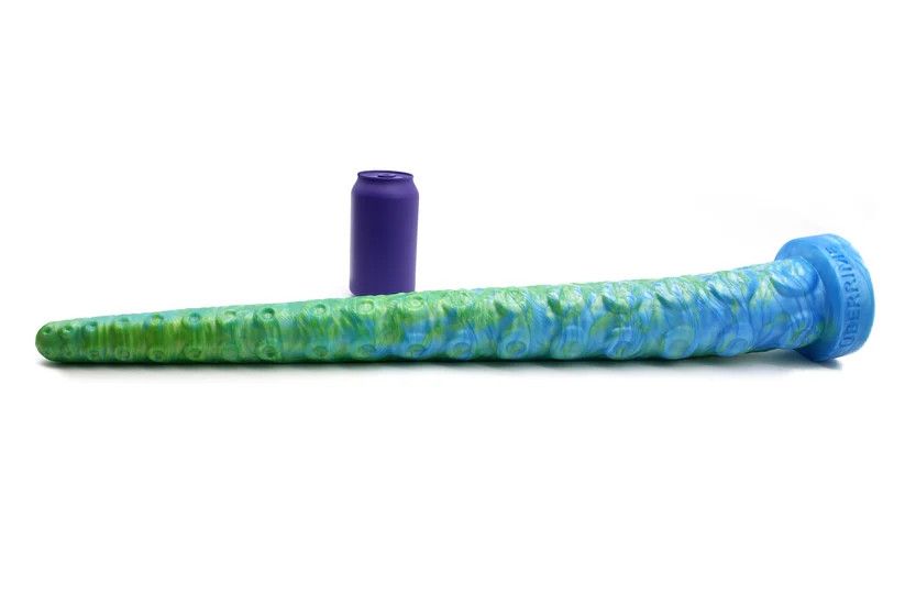A giant green and blue tentacle absolutely dwarfs the soda can next to it as a size reference.