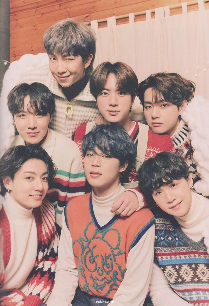 Jungkook, Hobi, Namjoon, Jimin, Jin, Yoongi and Tae wearing various winter sweaters.