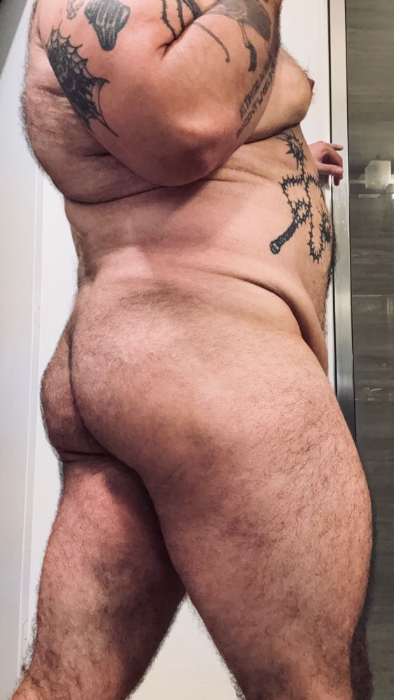 A thick legged Mexican boy with tattoos poses for the camera post workout. His fat ass hanging off the top of his legs invitingly. Weapons tattooed on his tummy 