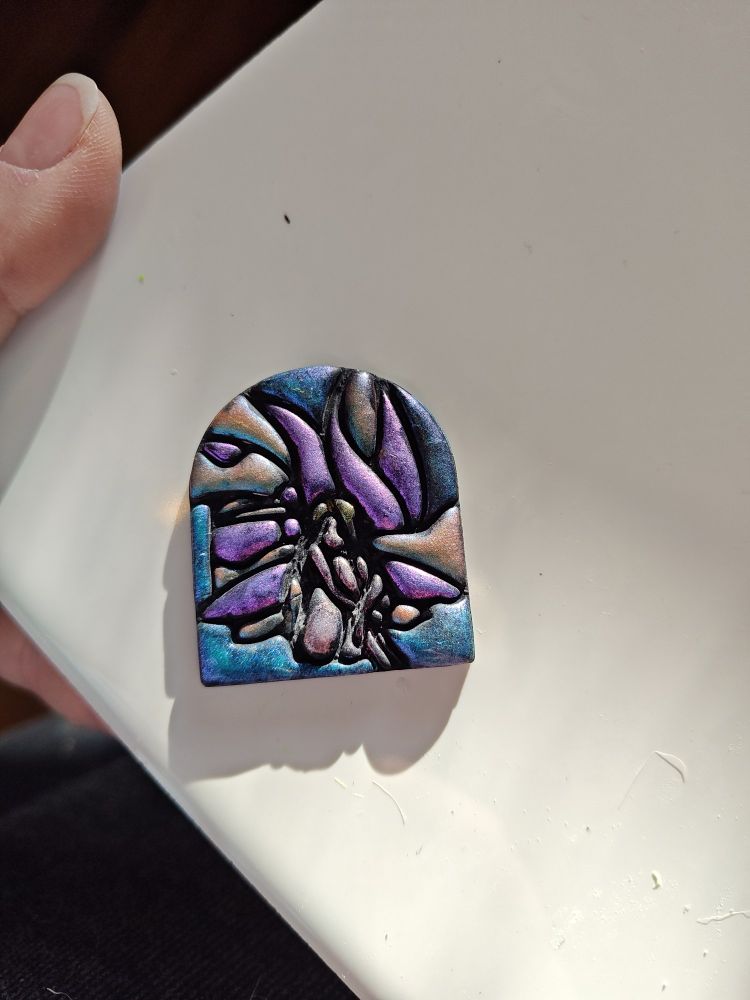 A stained glass fairy in iridescent colors.