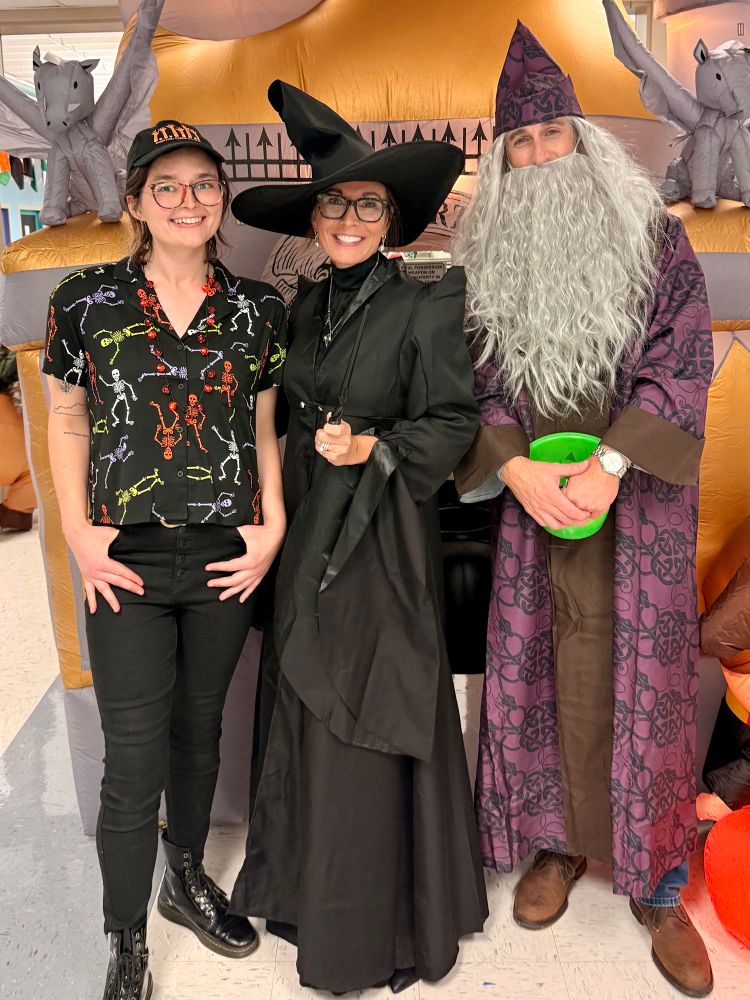 Emma poses for a photo with staff at Southern Elementary School, all dressed in Halloween attire