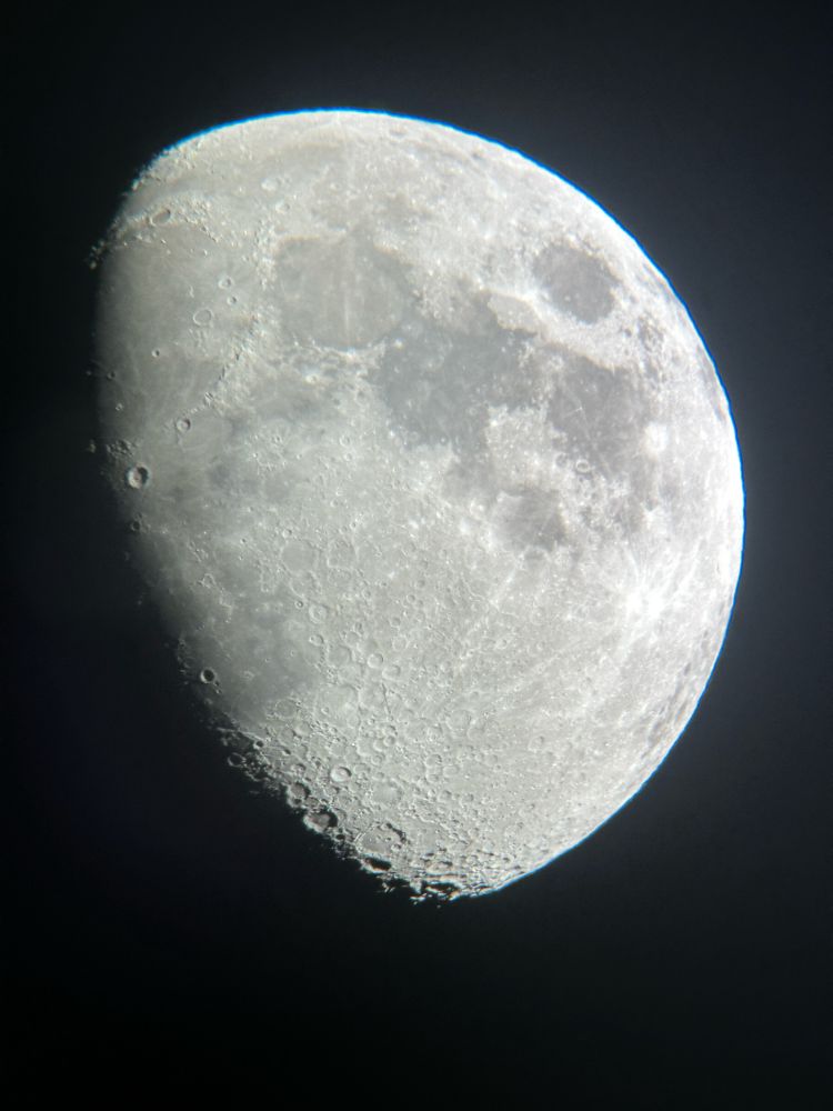 A moon in closeup, showing lots of small craters alone with big ones.