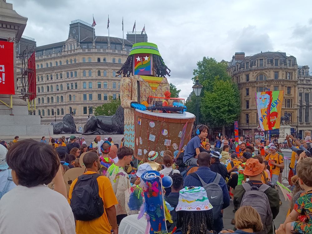 A giant animatronic bongo drummer with a DJ booth above the drums playing music