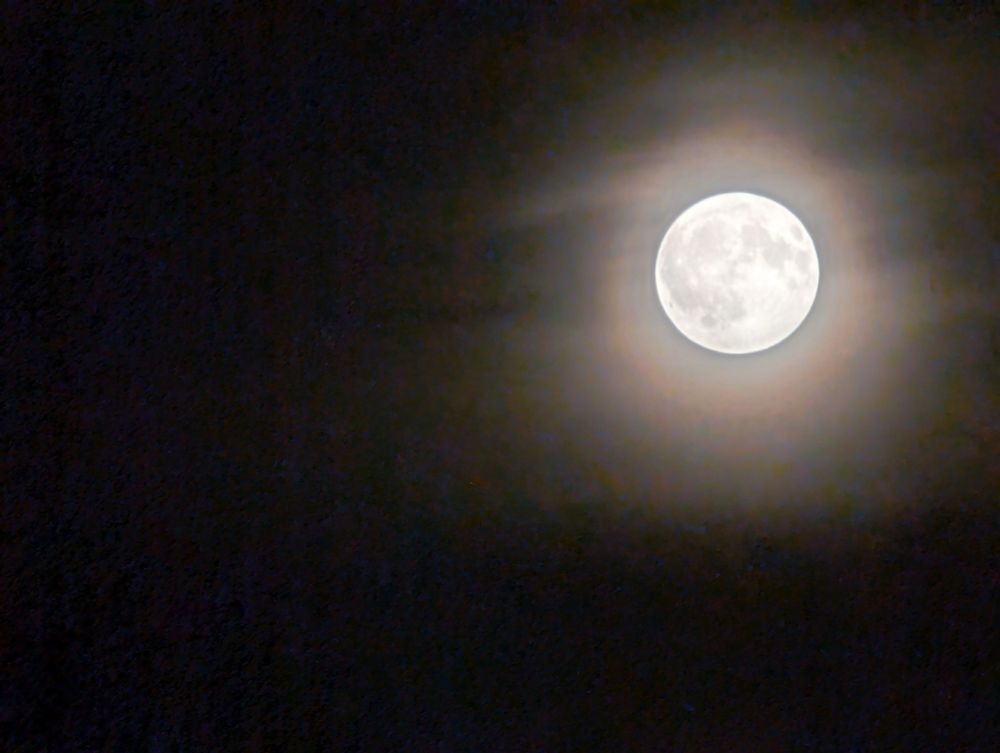 Full moon in a hazy dark sky