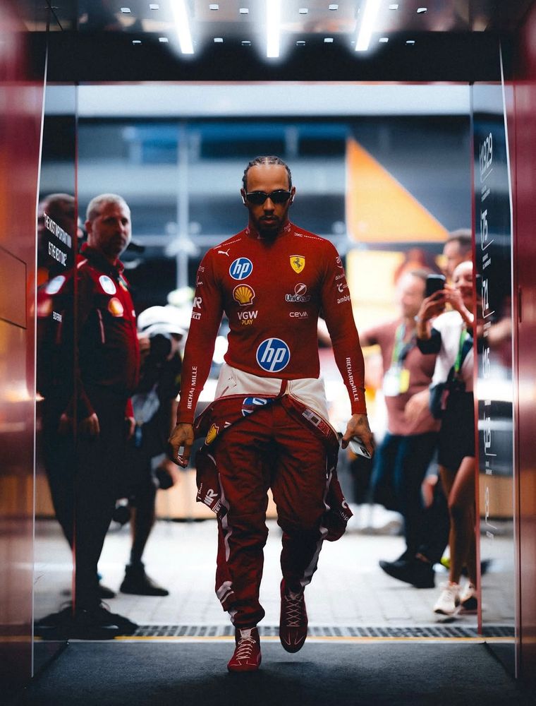 Lewis Hamilton walking into the Scuderia Ferrari garage