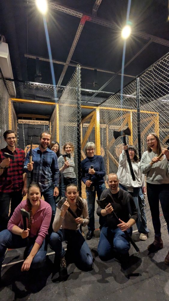 A group picture of people holding various axes and screaming like barbarians.