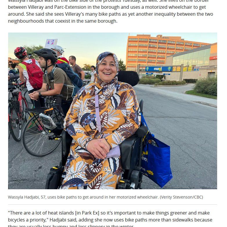 Photo of smiling woman wearing brightly colored dress and head scarf on a power wheelchair. She is on a road (at a protest) and a crowd of people with bicycles are in the background. Caption: Wassyla Hadjabi, 57, uses bike paths to get around in her motorized wheelchair.