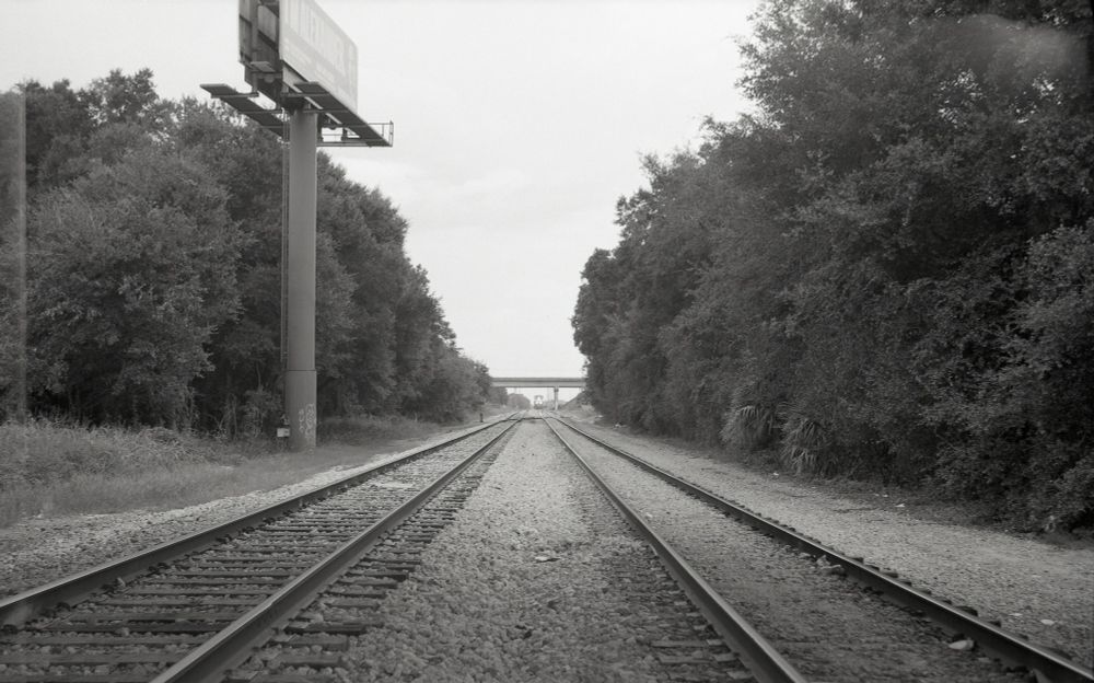Test shot from a Voigtlander Bessa II - train tracks, shot from under an overpass on overcast day (light leak still visible) 