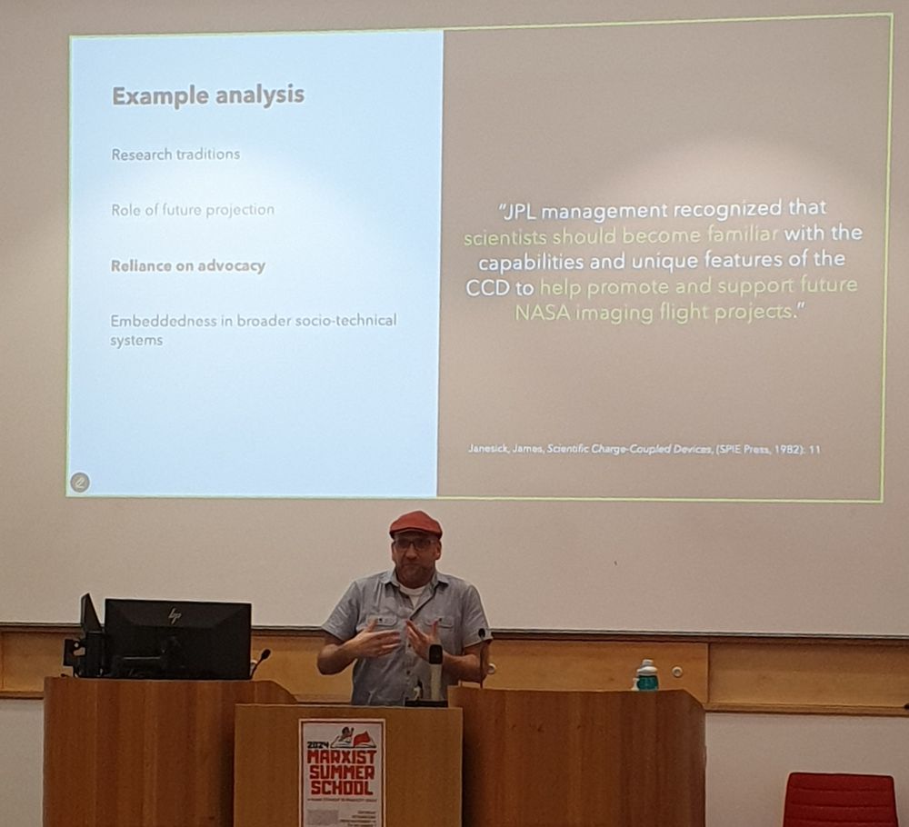 Carl presenting at a seminar. Screen behind him has a quote from James Janesick describing how JPL recognised that scientists should become familiar with the CCD.