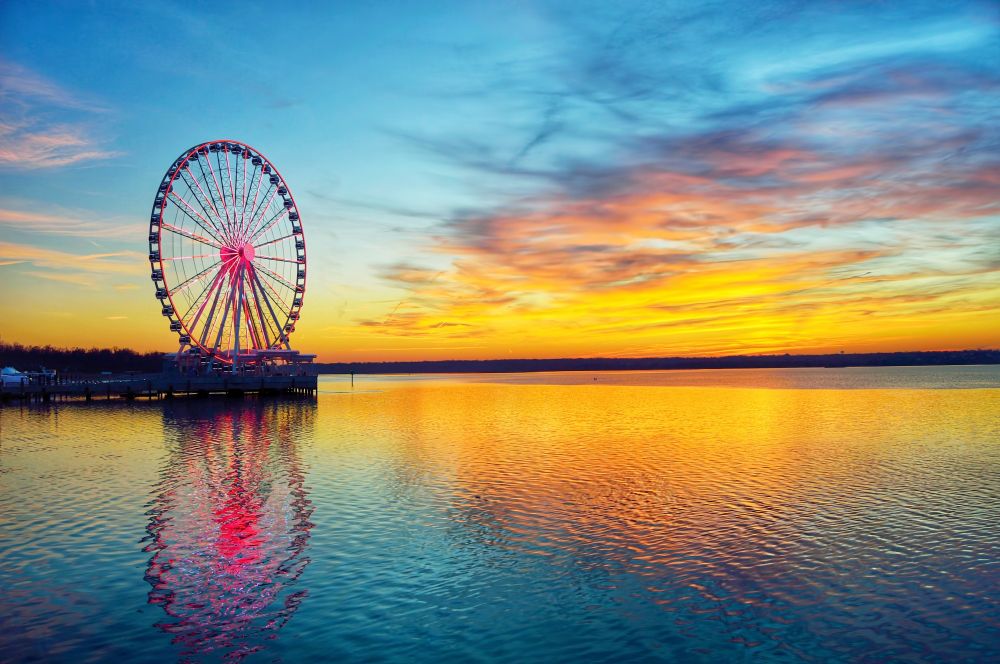 National Harbor Ferris Wheel reflecting off the water at the golden hour