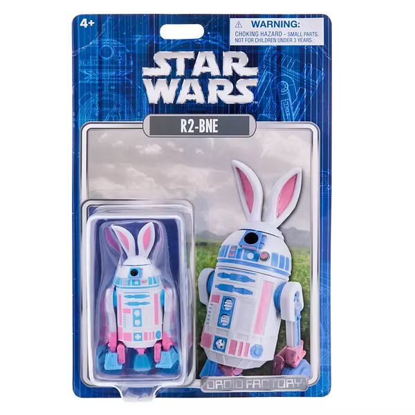 A toy package for a Star Wars astromech action figure named R2-BNE. It is colored pink, white, and light blue and has rabbit ears