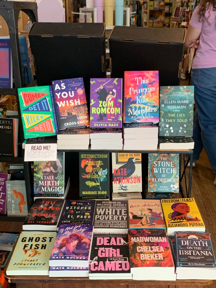A display of new paperback releases including “The Extinction Capital of the World” by Mariah Rigg