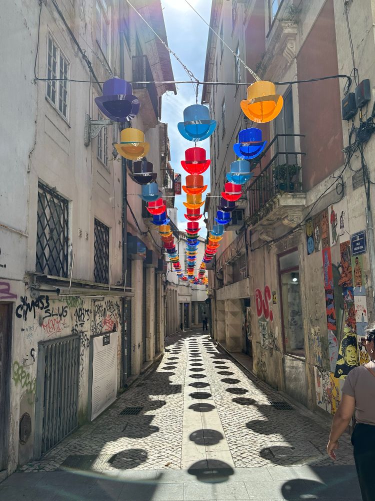 Street in the old town of Coimbra, with colourful top hats hanging