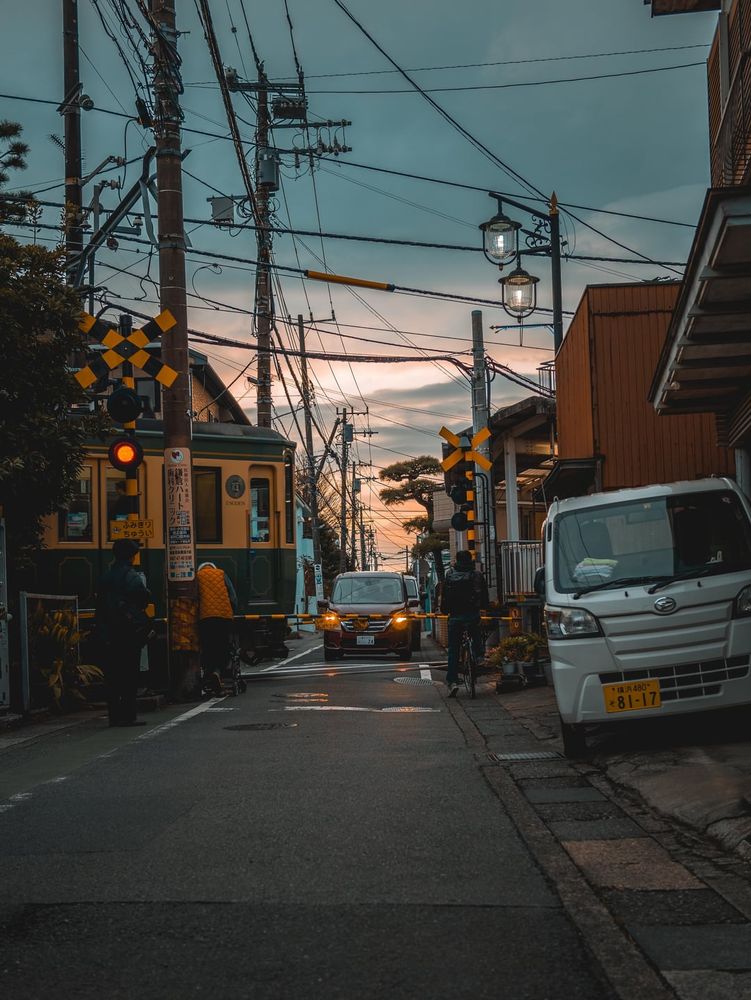 Train rolling through a crossing in Kamakura. Wadazuka station