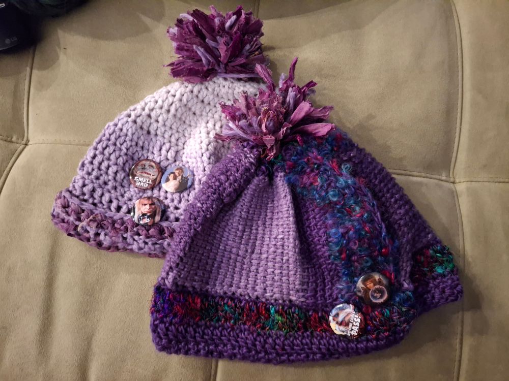 The hat I made for my husband layered over the older, simpler hat I made for myself using only one type of sari yarn (the one used for the pom pom on my husband's hat), and the gradient wool/silk as also featured on my husband's hat.  There are three Labyrinth pins on my hat.