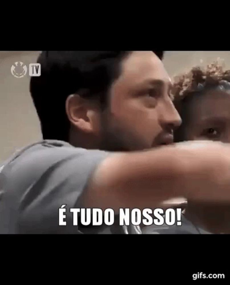 a man with a beard is hugging another man and says e tudo nosso !