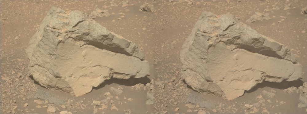 A dual left/right stereoscopic pair of ochre-toned photographies capturing a Martian rock. This dual image is intended to be used to obtain a Stereo3D rendition of the scene through parallel viewing, and not cross-eyed viewing.