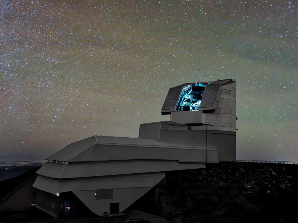 NSF–DOE Vera C. Rubin Observatory can be seen here under a starry sky with the dome lights on.