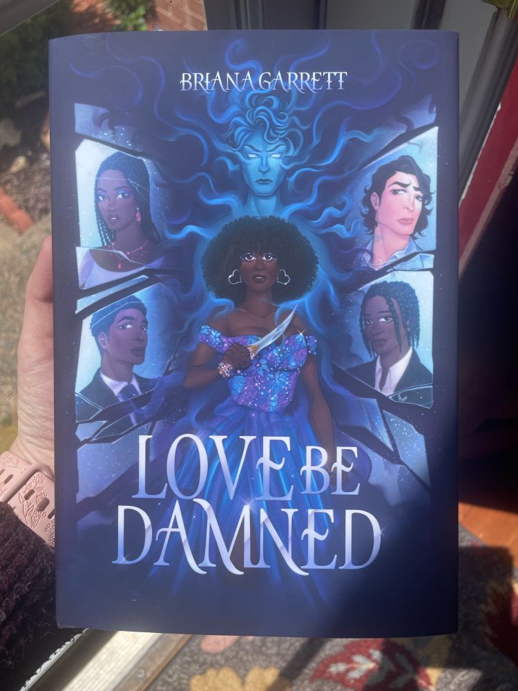 Physical copy of Briana Garrett’s novel, Love Be Damned
