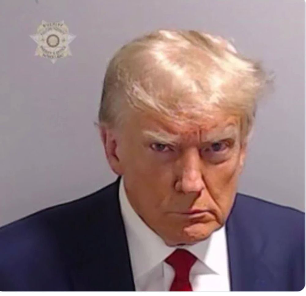 Donald Trump scowling in his mug shot in Fulton, Co. Georgia.