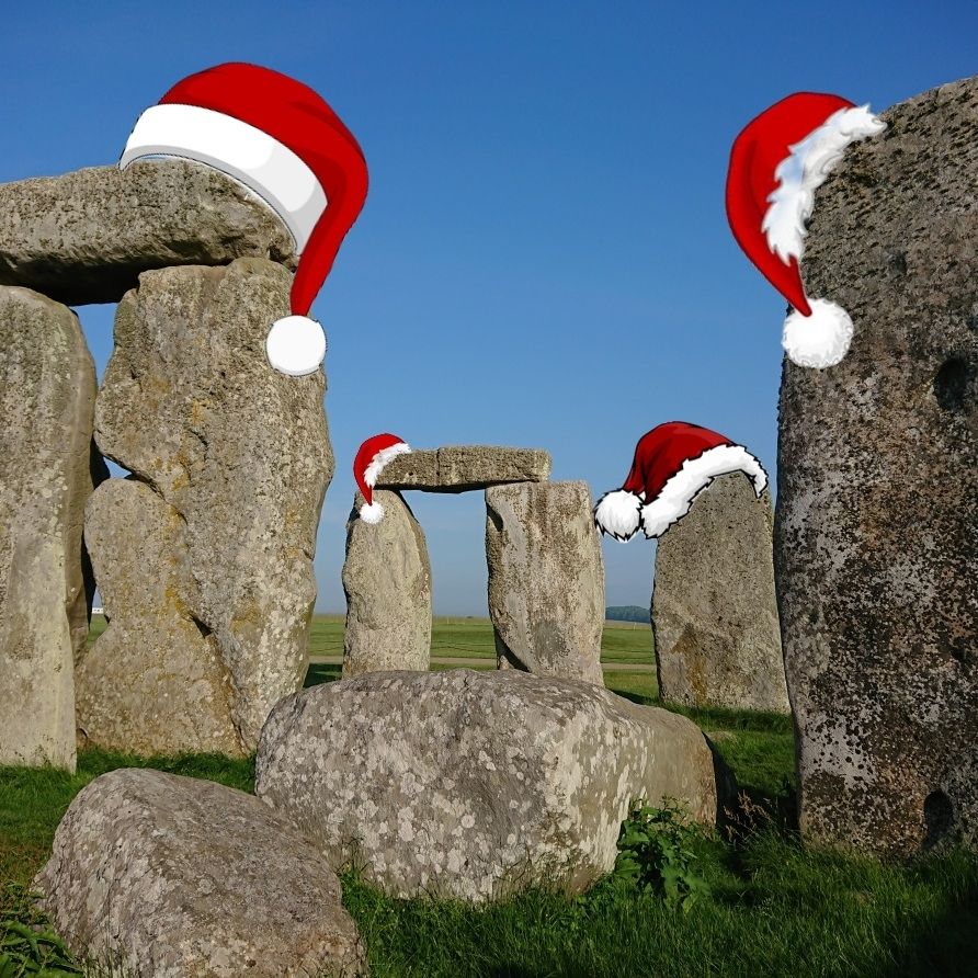 The stones of Stonehenge wearing Christmas hats