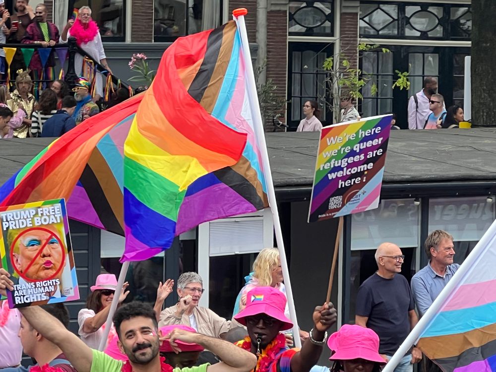 Rainbow flags and sign saying Trump-free boat