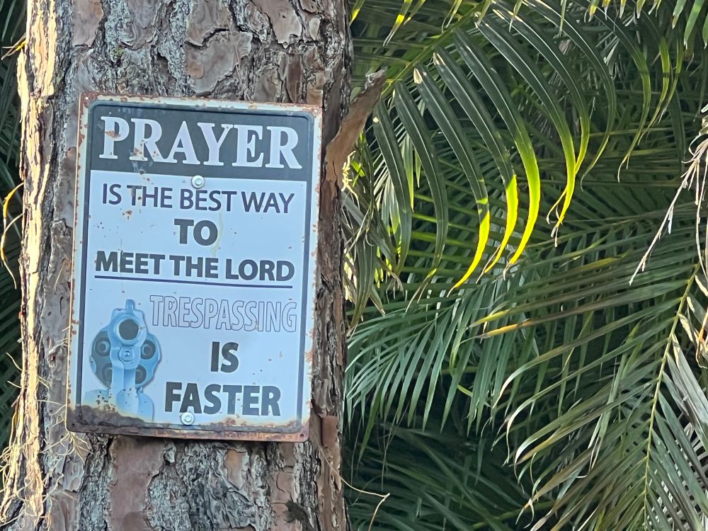 Sign on a tree that says, Prayer is the best way to meet the Lord. Trespassing is faster. 