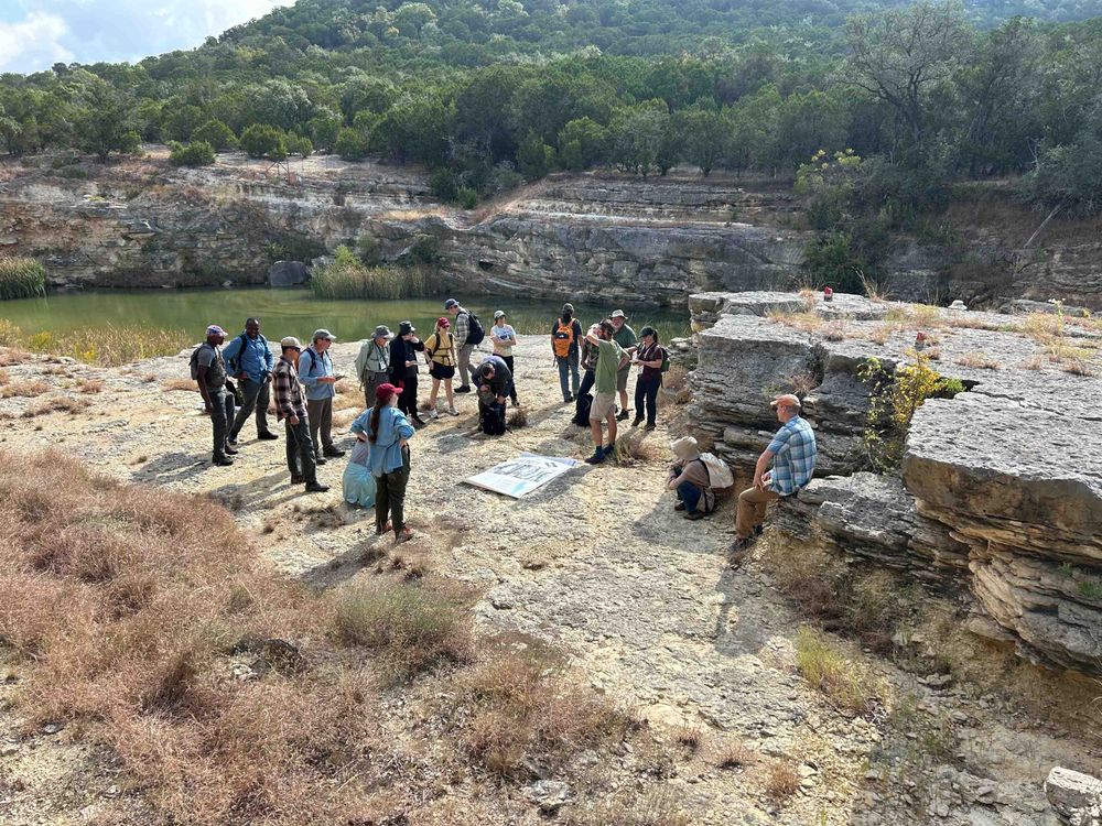 A group of people stand around a gorge near Canyon Lake in Texas. 