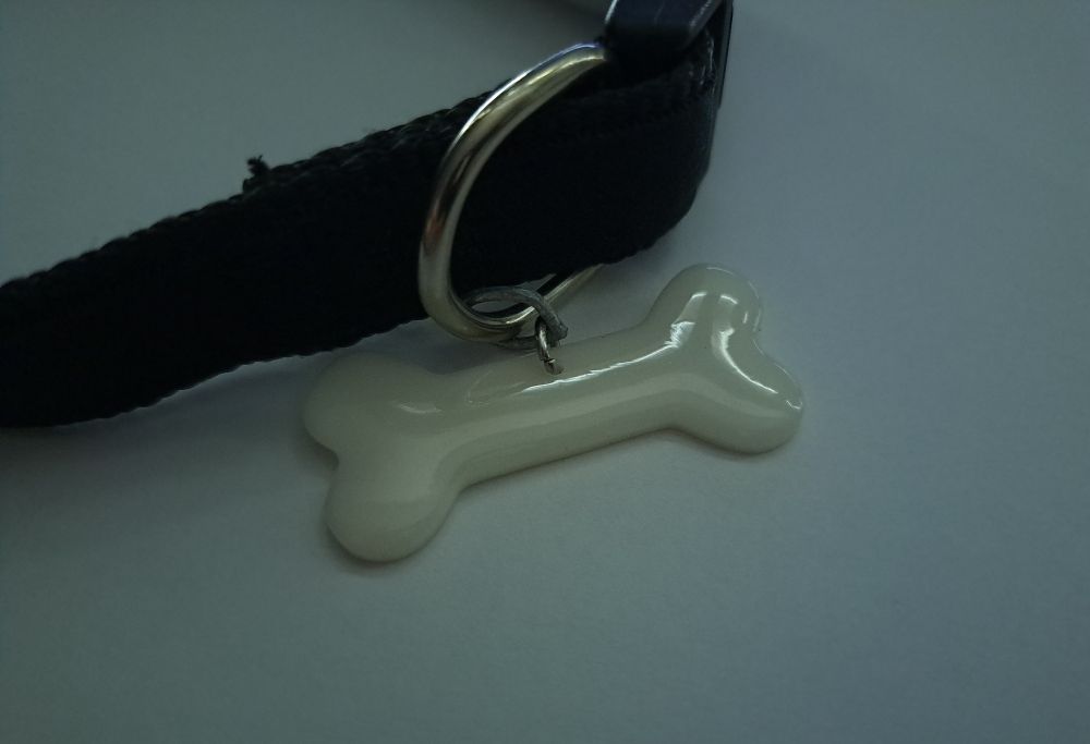 a bone shaped resin craft on a collar