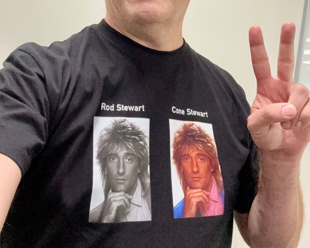 Me wearing a shirt with a black and white captioned photo of Rod Stewart, and an adjacent color version of the same photo captioned “Cone Stewart” 