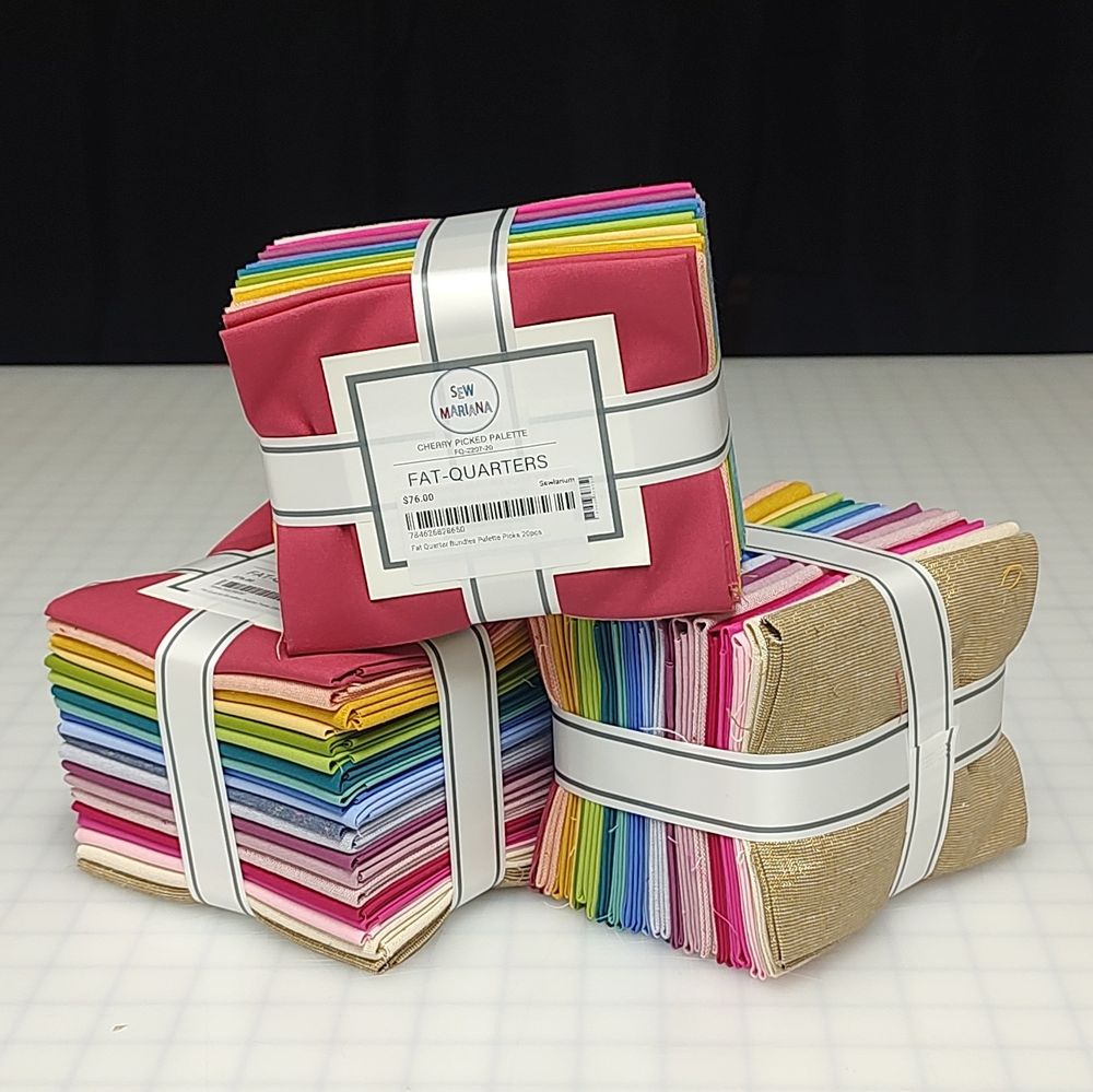 stack of fat quarter bundles with a rainbow of colors in each