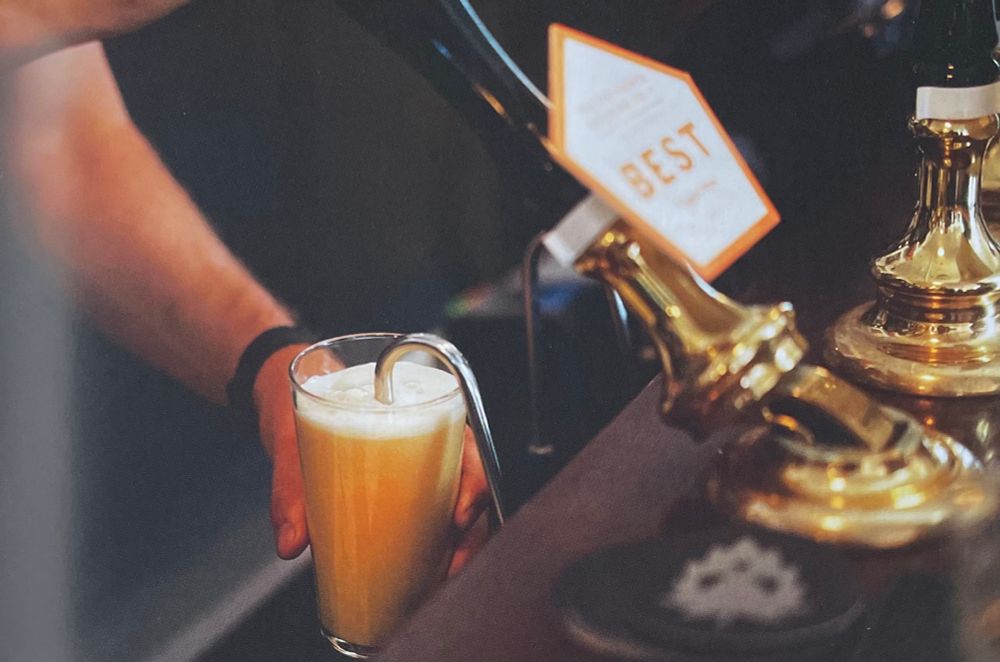 Pint of Five Points ale being pulled from a hand pump into a conical glass.