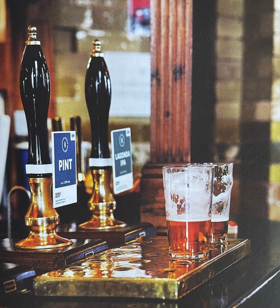 Two pints on a bar. One conical glass and one nonic.