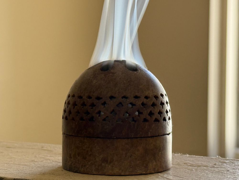 Domed censer issuing smoke from its top