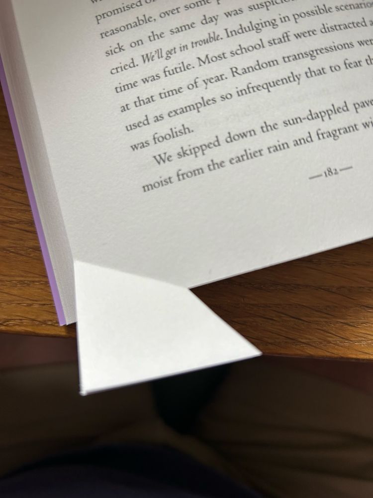 A badly cut page in a published novel resulting in the bottom left corner reaching out like an elephant leg from the rest of the book 