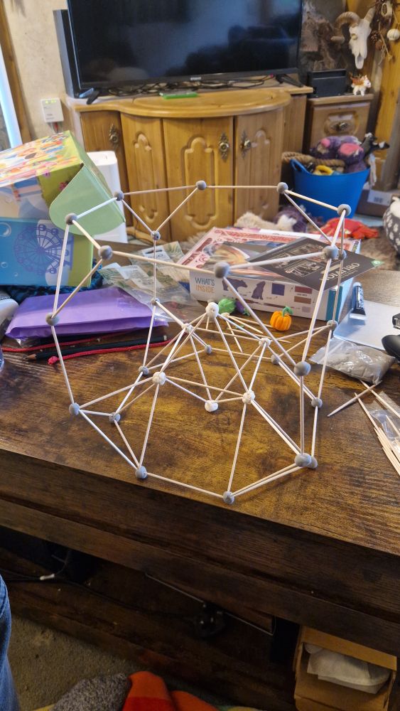 Photo of a model of a truncated cube with a construction aid (inlaid square cupola with inlaid octahedron). Truly the turducken of stick-and-ball constructions. Made from cocktail sticks, air-dry clay and play dough.