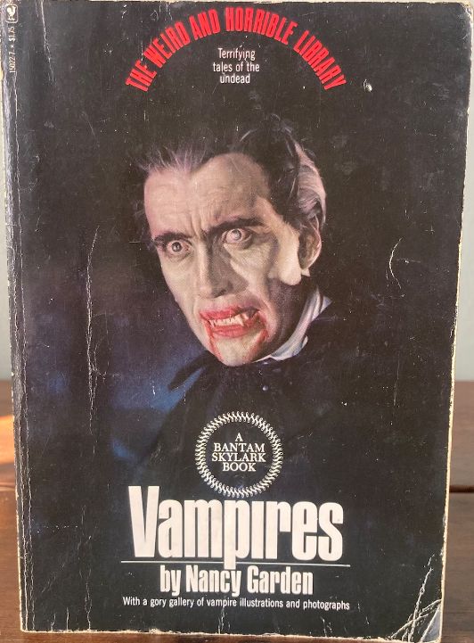 Black background with a vampire, in the similar style of Dracula by way of Hammer Films - a white man with a pale face, slicked back black hair and blood-red, blood-smeared lips. 