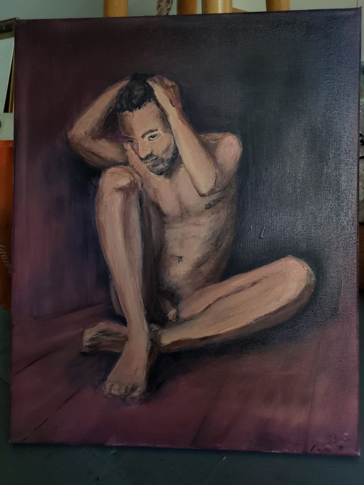 Oil painting of male nude sitting in corner of room. One leg is vertical and the other is horizontal to the floor. Both legs are folded closed. Painting is 16×20
