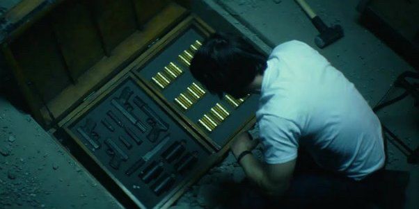 John Wick unearthing his guns and coins from under his basement 