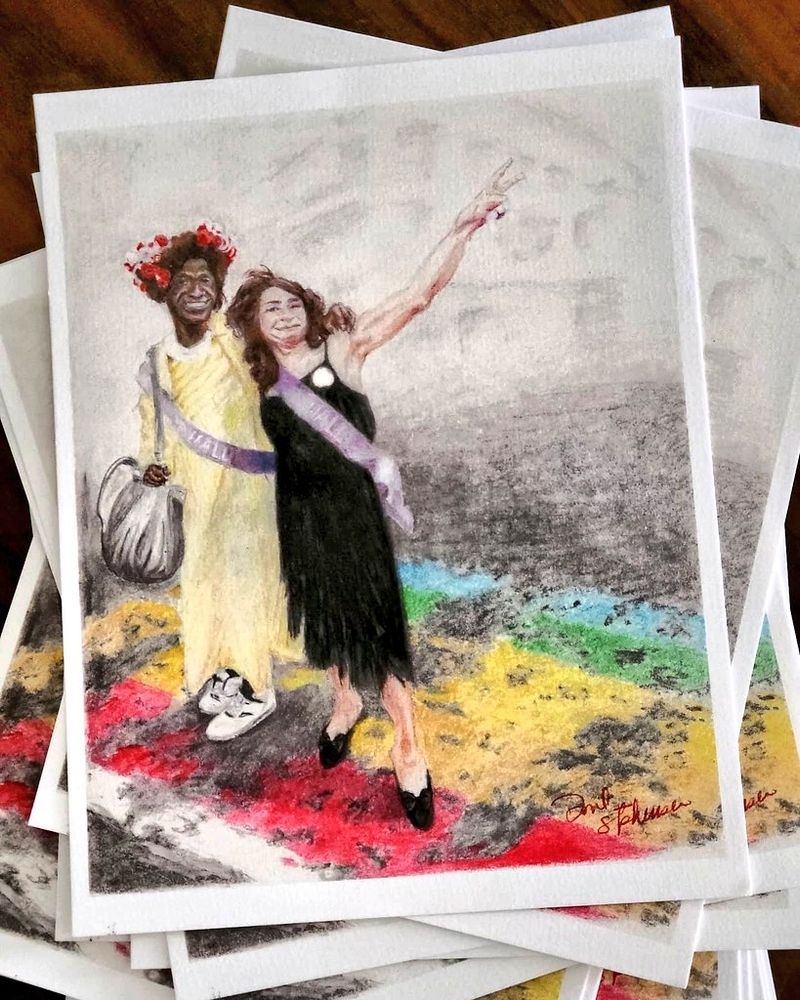Colored pencil drawing of Marsha P Johnson and Silvia Rivera wearing sashes standing on a rainbow painted road.